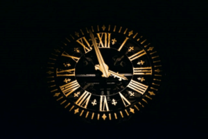 Our Online Community Welcomes You - Gold old fashion clock on a black background